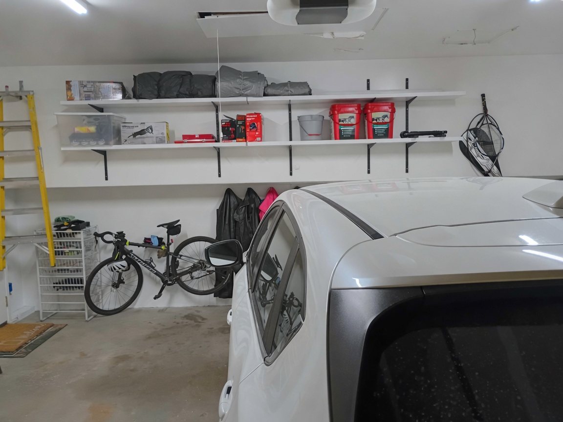 AI mockup of a Cottage Grove garage interior with white walls and white shelves