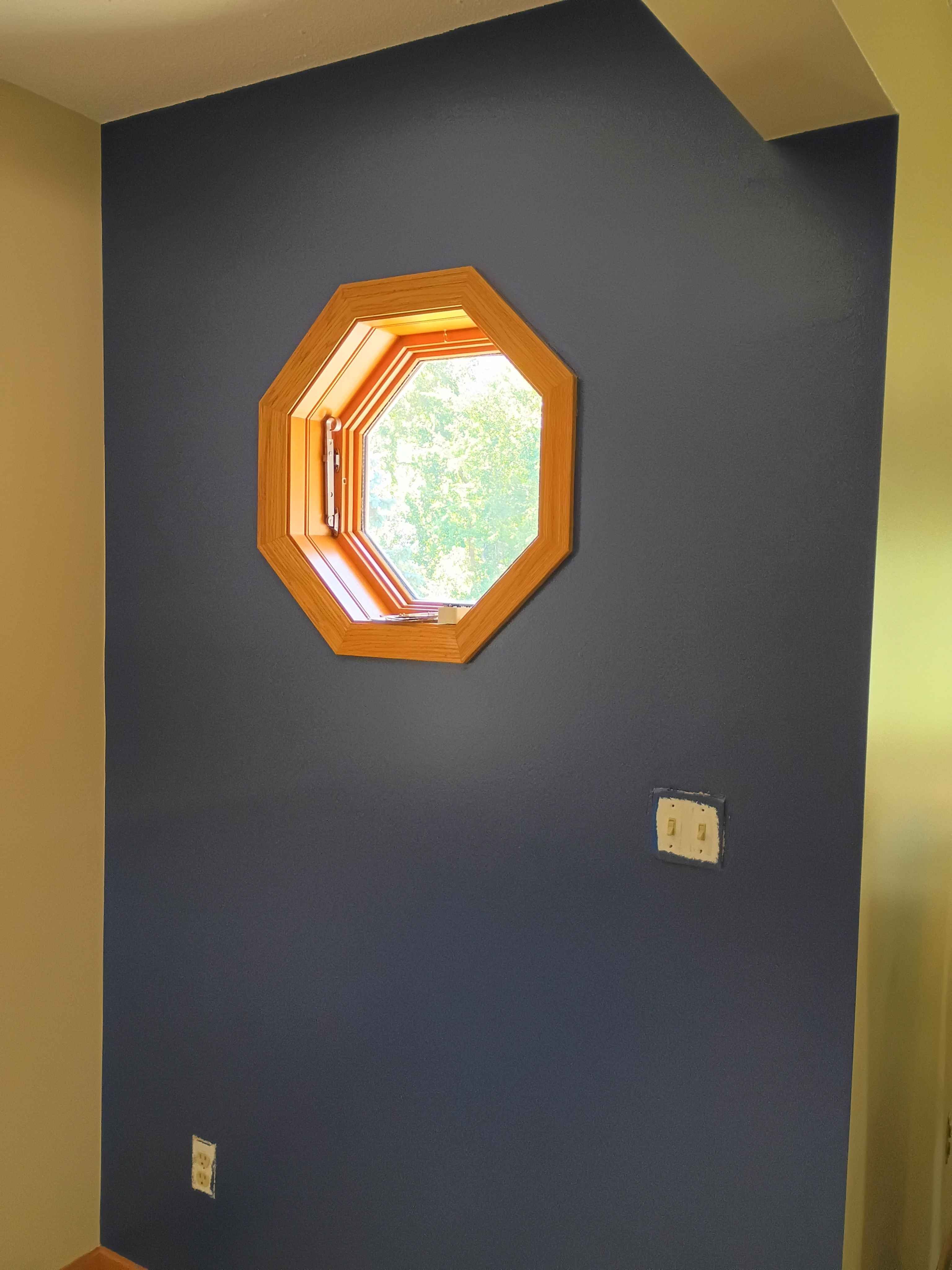 Ham Lake entry accent wall painted navy around an octagon window