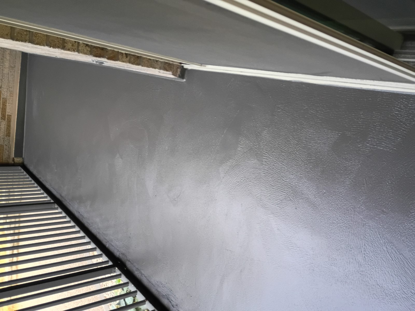 Close view of satin Forte on textured concrete balcony